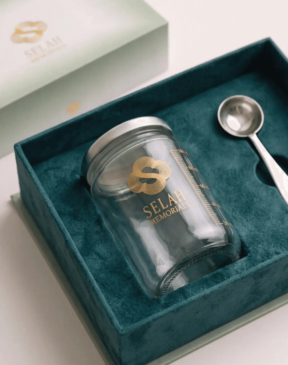The etched glass vial and scoop inside the kit box