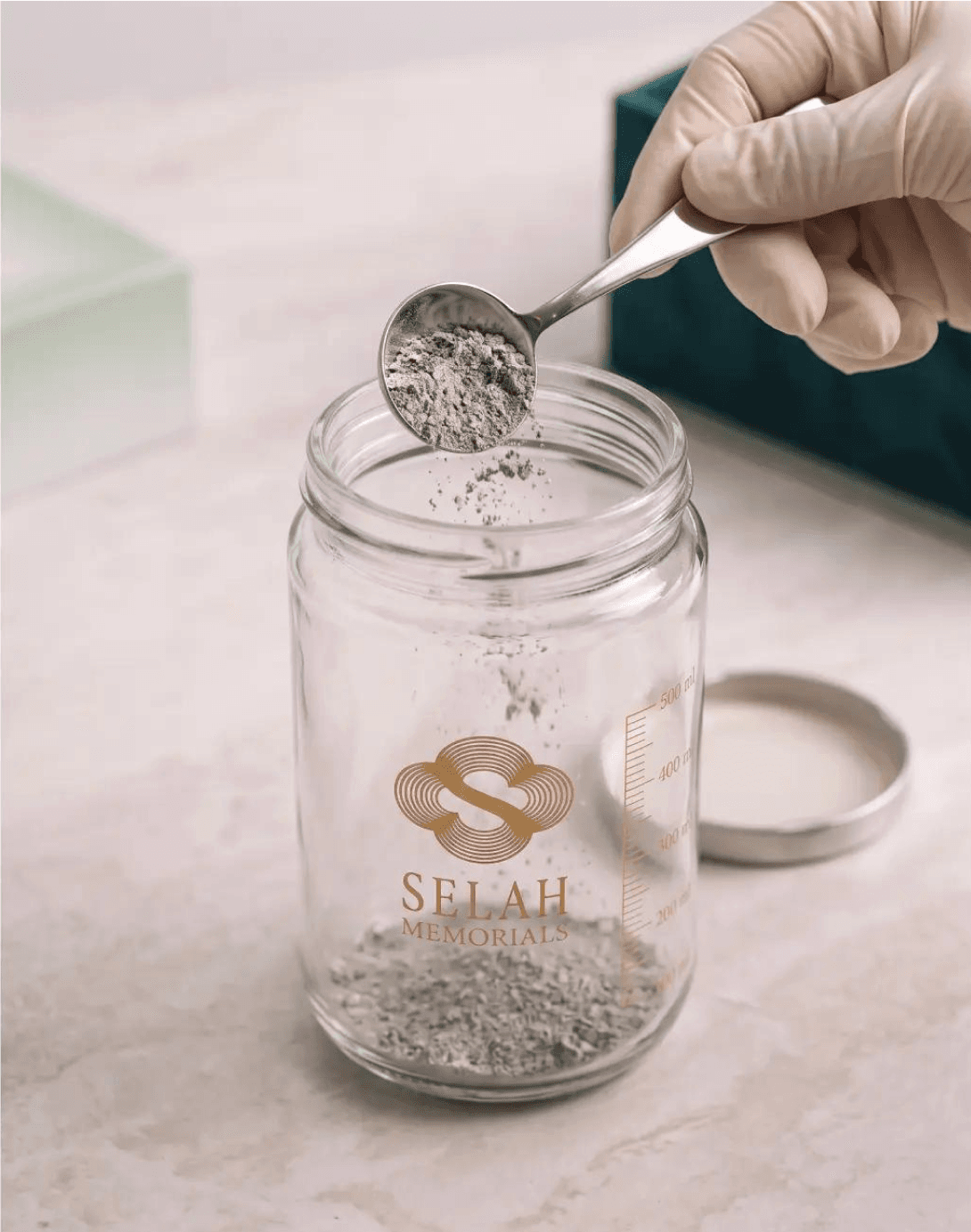 A sample of ashes being scooped into the kit's glass vial