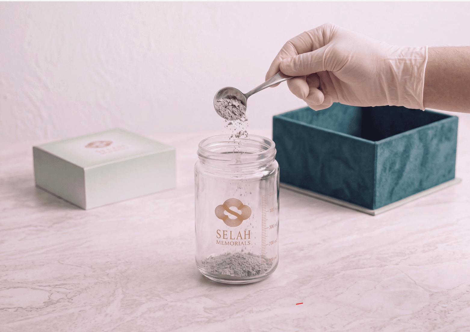 A sample of ashes being scooped into the kit's glass vial